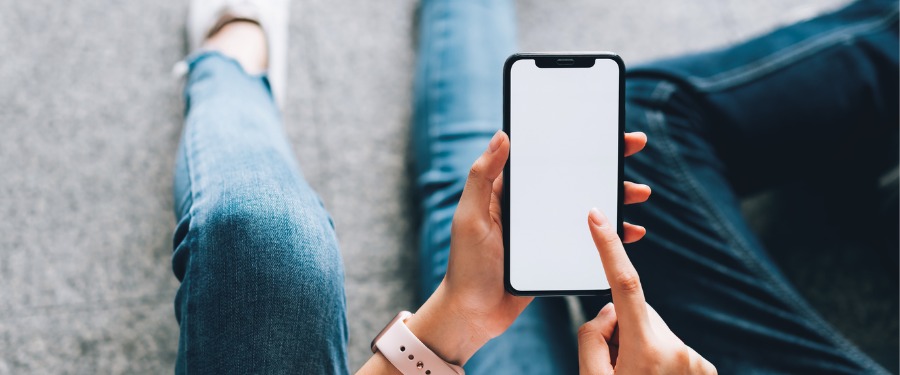 Woman using iPhone to search for clinical trials