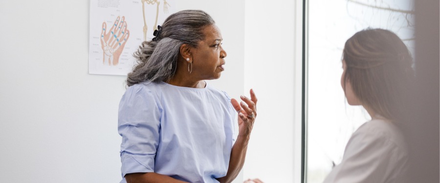 Older Black woman discussing Alzheimer’s disease clinical trials with her doctor