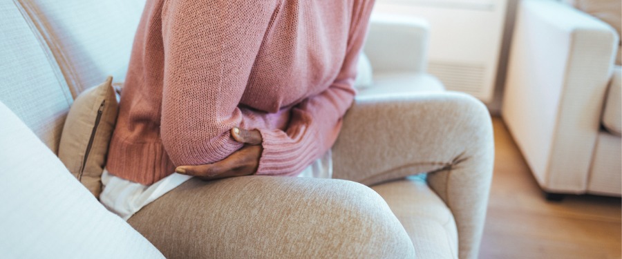 Woman experiencing stomach pain due to celiac disease Woman experiencing stomach pain due to celiac disease
