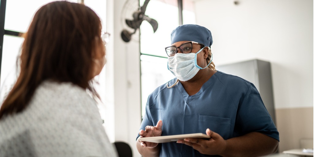 Doctor talking to patient during medical appointment in a hospital. 