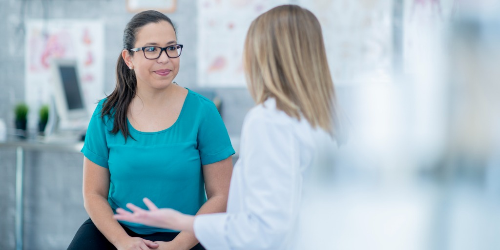 Doctor speaking to a patient about the patient’s diagnosis. Doctor speaking to a patient about the patient’s diagnosis.