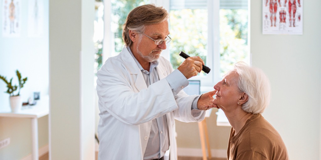 Doctor performing eye exam on patient