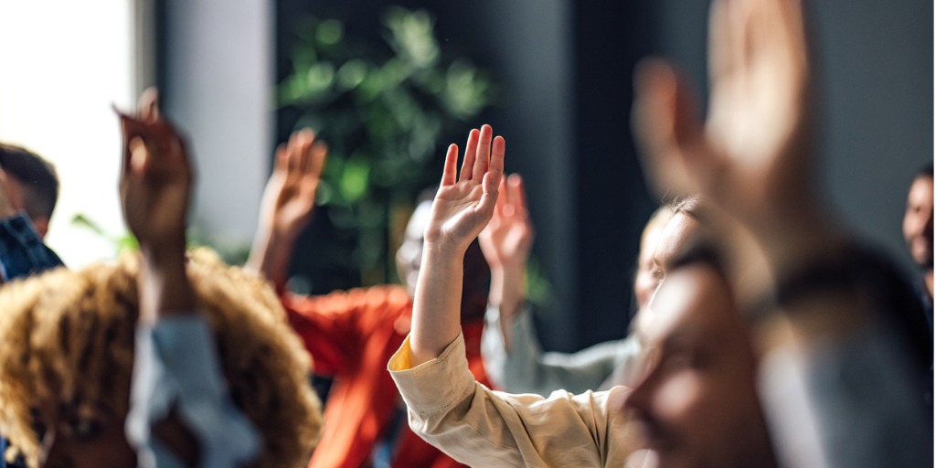 group-of-anonymous-people-raising-hands-on-a-seminar-picture-id1408304009