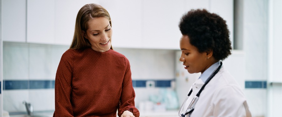 Female doctor going over clinical trial protocol with female patient