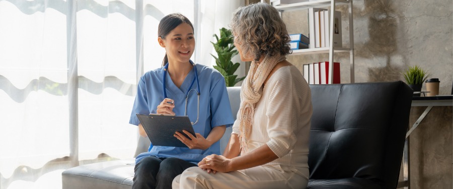 Woman discussing MS clinical trials with female nurse