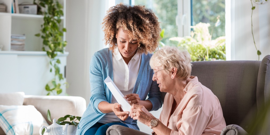 Home nurse taking care of elderly woman