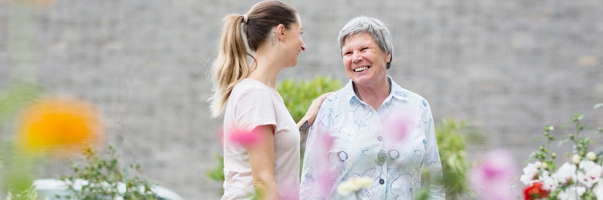 Older MS patient talking with caregiver