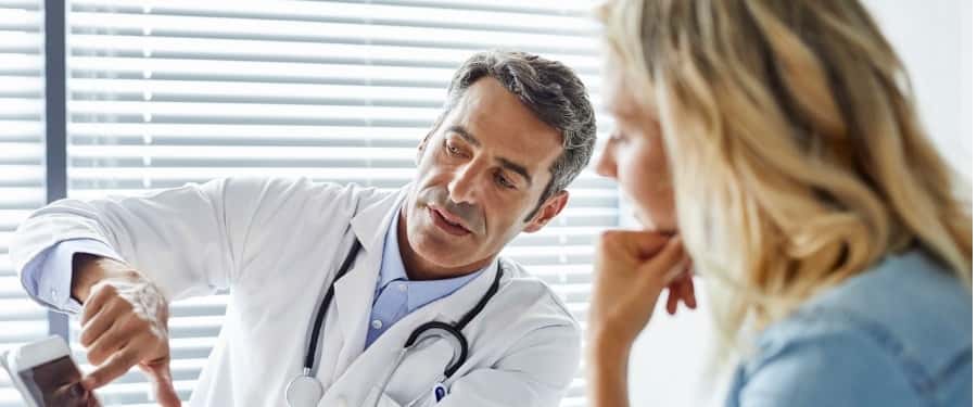 doctor showing tablet to patient