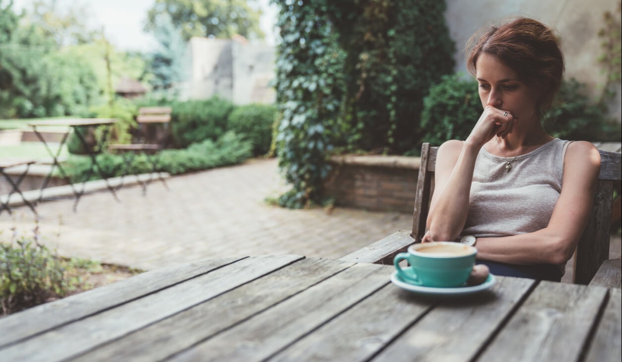 Depressed woman drinking coffee