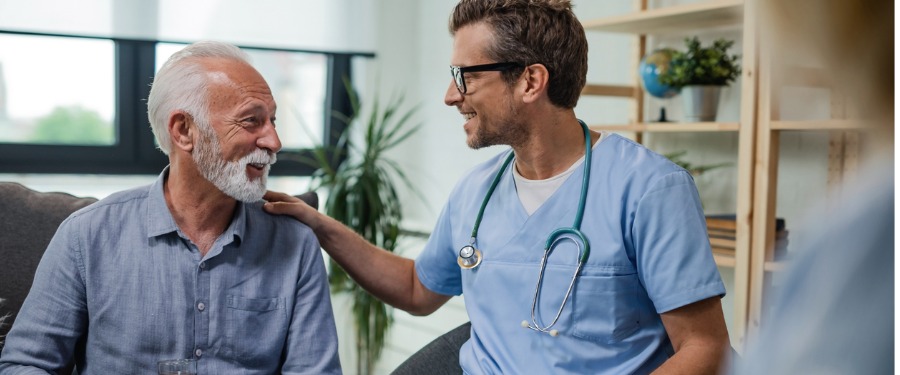 Young male doctor discussing clinical trial compensation with older male patient