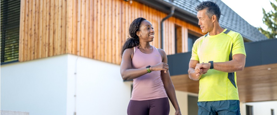Walking man and woman dressed in fitness apparel