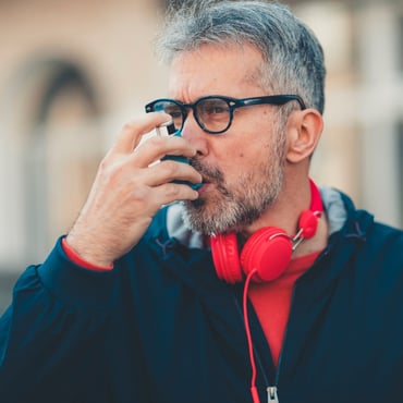 man-using-an-asthma-inhaler-picture-id1140574879