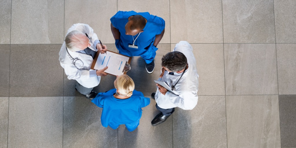 Doctors speaking in a hospital lobby