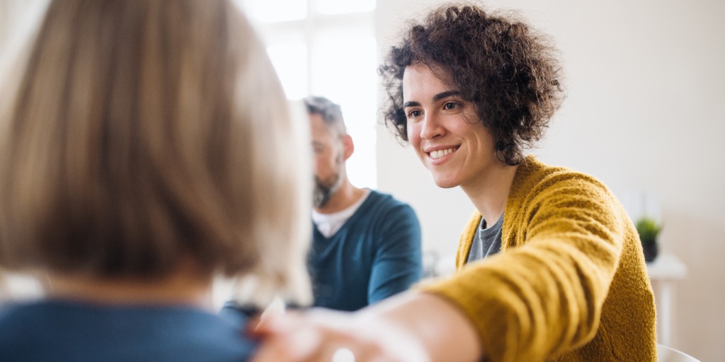 men-and-women-sitting-in-a-circle-during-group-therapy-supporting-picture-id1132974918