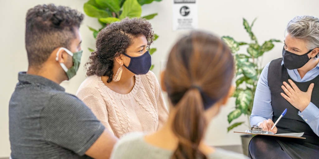 A multi ethnic group of therapy session at a medical office.