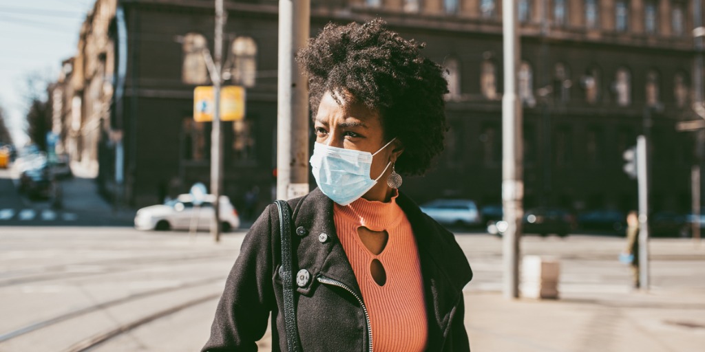 portrait-of-young-woman-with-mask-on-the-street-picture-id1213302592