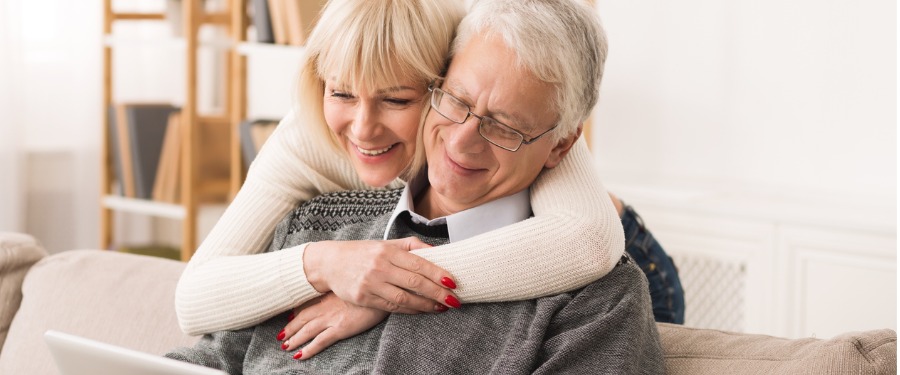 Senior couple learning about Alzheimer’s myths on tablet