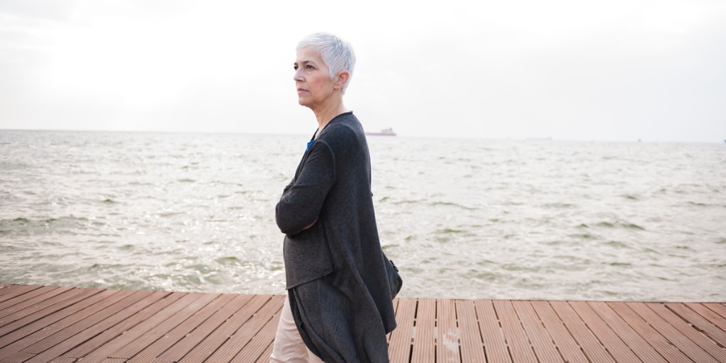 Mature business woman at coast, walking