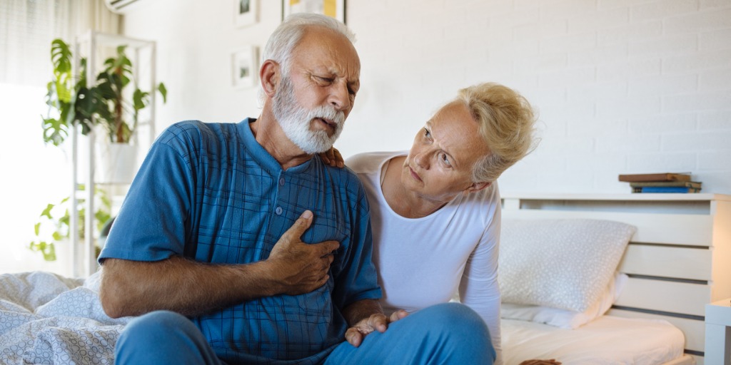 Senior man telling his wife about chest pain Senior man telling his wife about chest pain