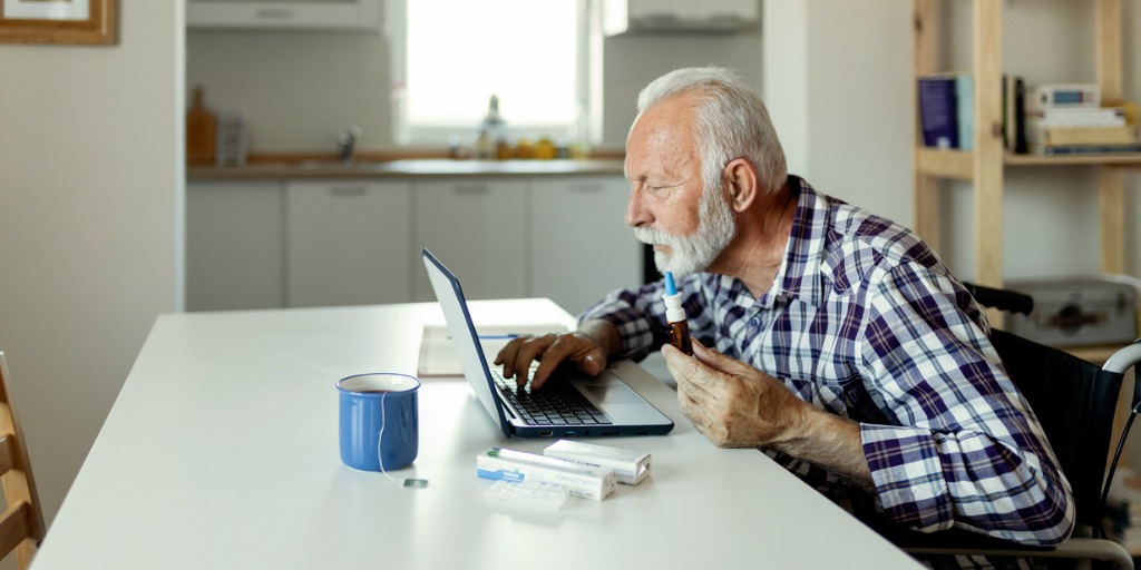 Senior man searching for information online about a treatment. 