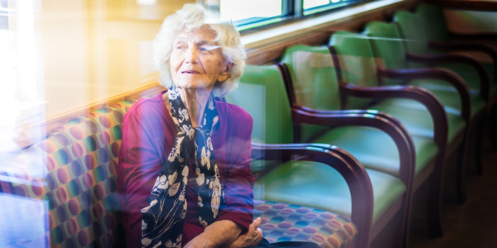 Senior woman sitting in a waiting room at a doctor’s office.