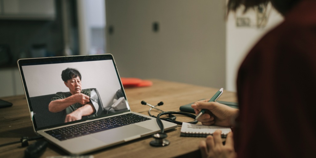 Telemedicine video conference with a patient at home.