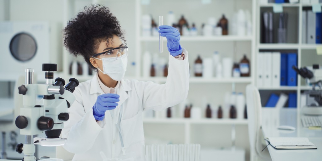 Cropped shot of a young female scientist inspecting a liquid sample in a test tube while working in a laboratory