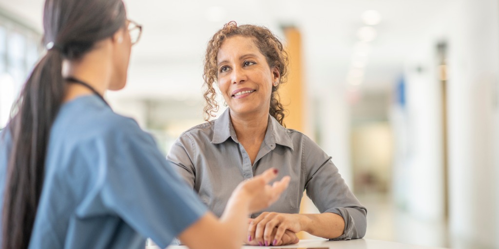 A female doctor is meeting with her female patient. 