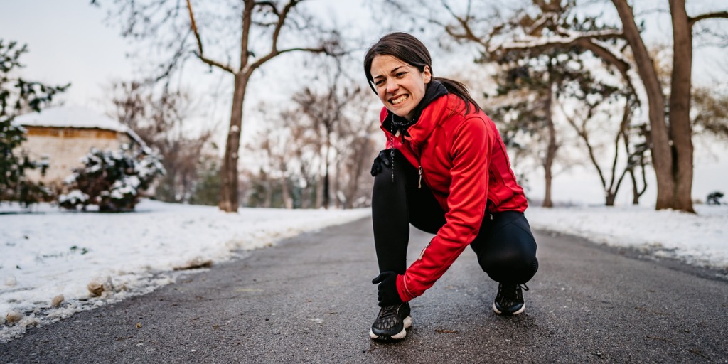 Woman with hurt knee during a walk.