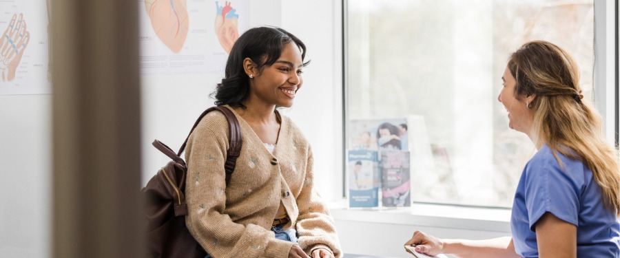 Clinical trial site staff member discussing research participation with patient