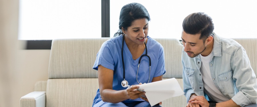 Female doctor discussing the importance health literacy with a male patient Female doctor discussing the importance health literacy with a male patient