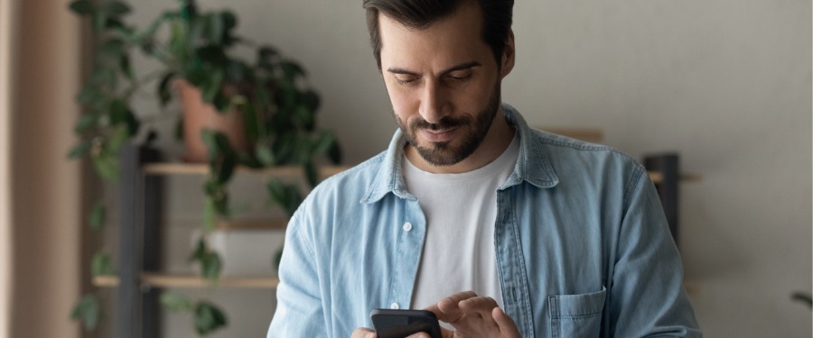 Man using cell phone to search for clinical trial Man using cell phone to search for clinical trial