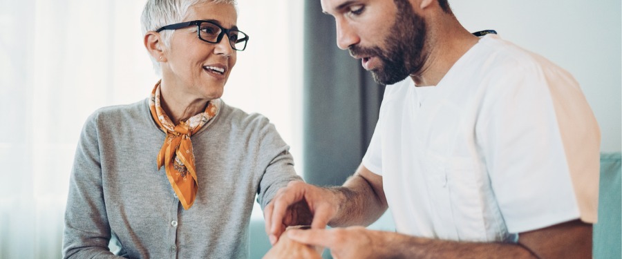 Male doctor discussing rheumatoid arthritis with female patient