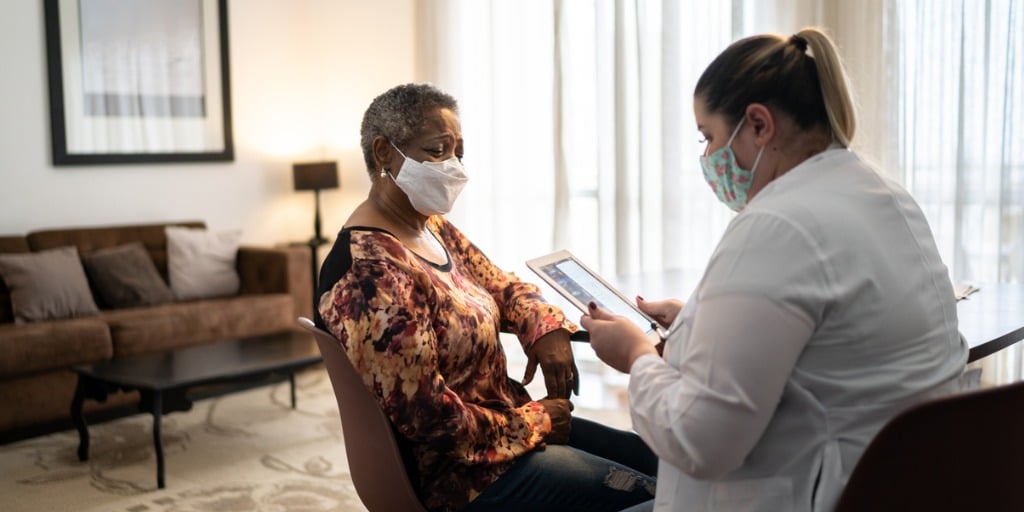 Doctor talking to senior female patient