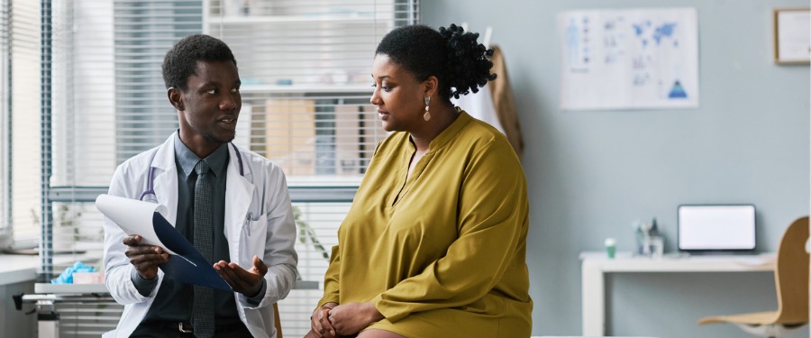 Black woman discusses clinical trial participation with her doctor