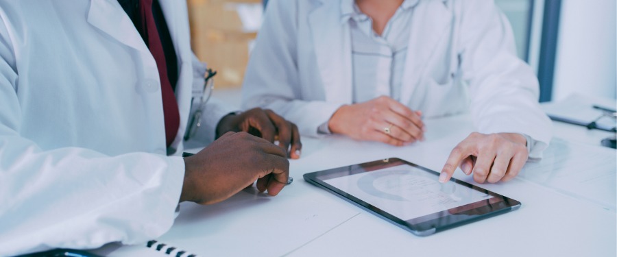 two doctors discussing rare disease treatment