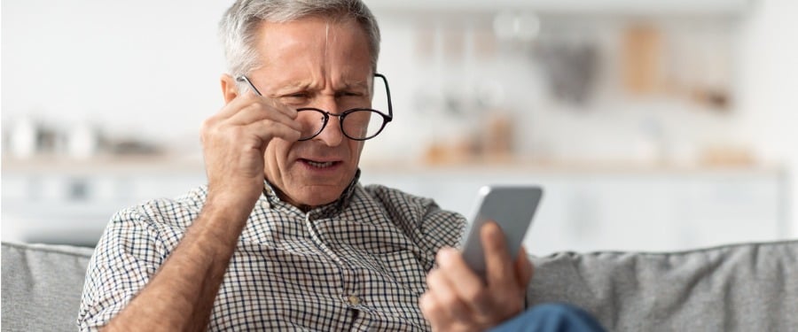 Older man struggling with presbyopia